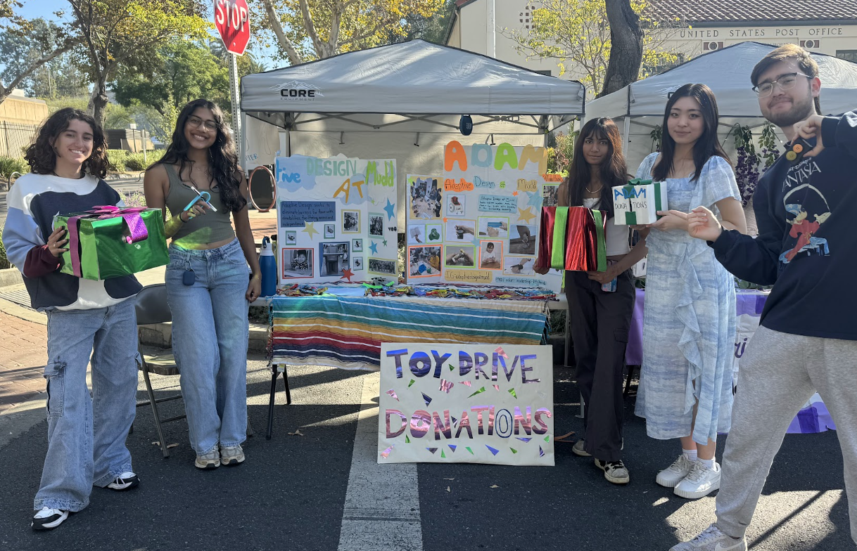 Adaptive Design at Mudd team members at a community toy drive with adapted products and project displays